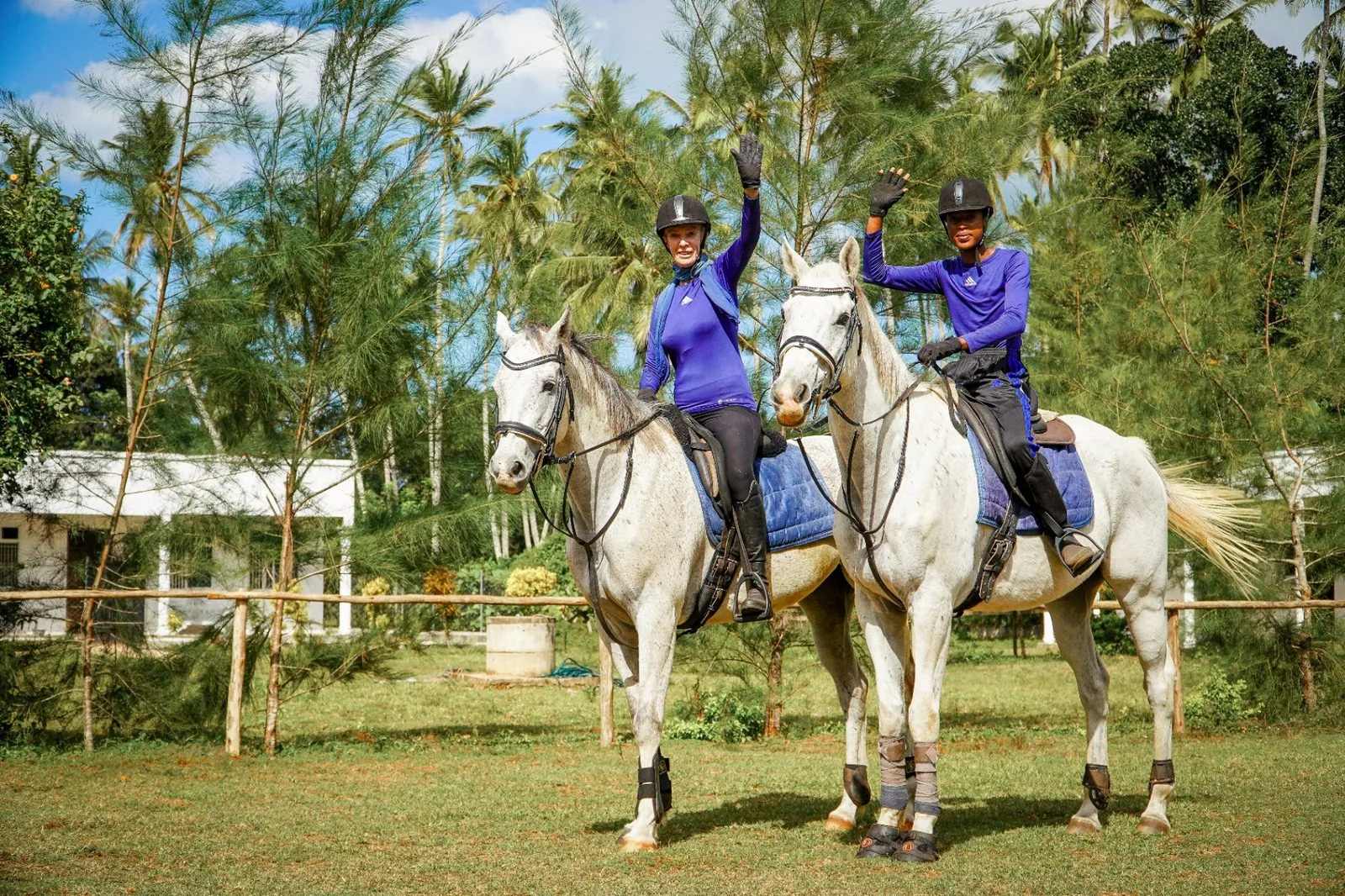 Riders waving during a forest ride at Anna's Riding Stables